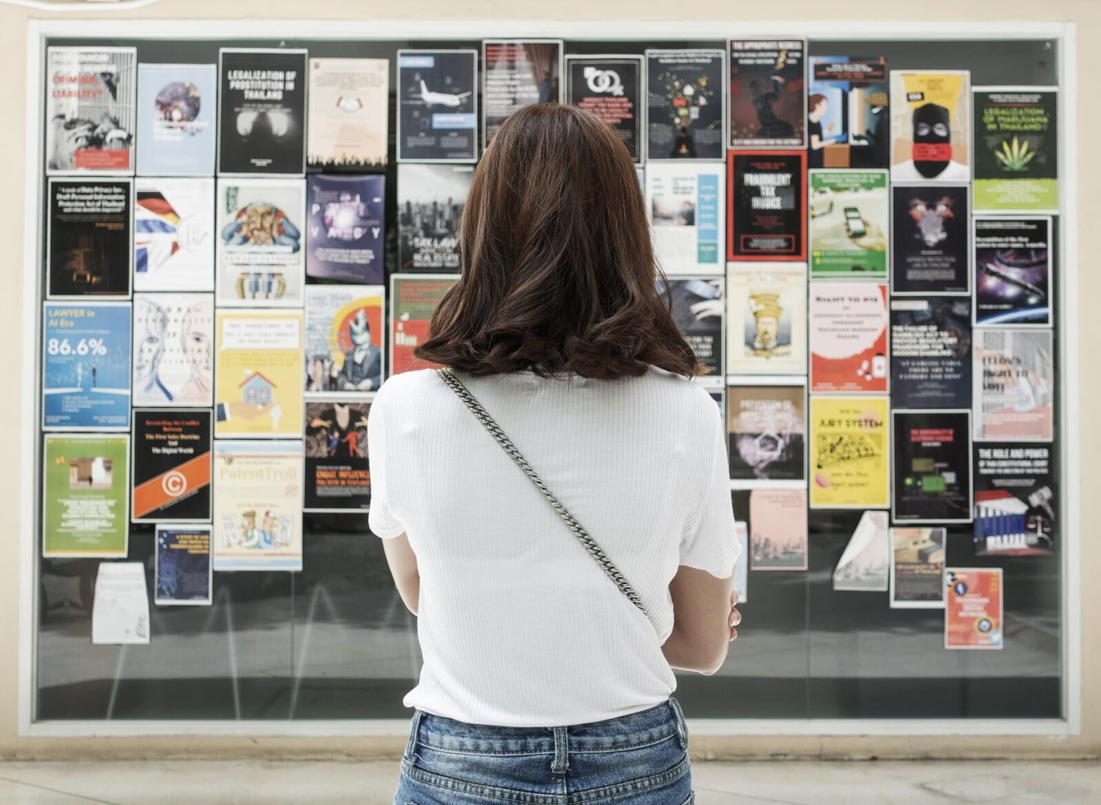 Female student reading posters